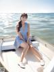 A woman sitting on a boat in the water.