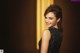 A woman in a black dress posing for a picture.