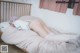 A woman laying on top of a bed in a bedroom.