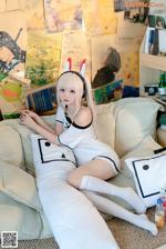 A woman sitting on top of a white couch.