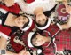 A group of three girls laying on top of a leopard print blanket.