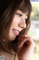 A close up of a woman with long brown hair.